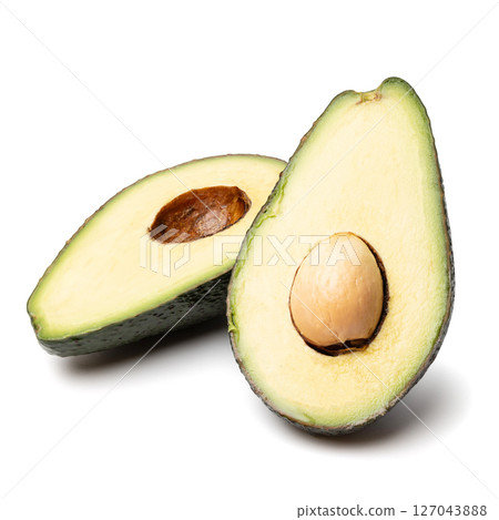 Healthy food and ingredients - Half of ripe organic green avocado fruit with pit isolated on white background with built-in clipping path Healthy food and ingredients - Half of ripe organic green avocado fruit with pit isolated on white background with built-in clipping path 127043888