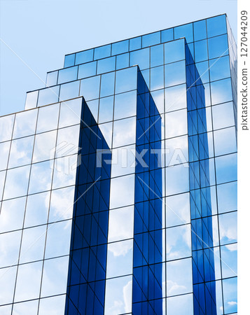 Modern building Glass facade Blue sky reflection Architecture details Modern building Glass facade Blue sky reflection Architecture details 127044209