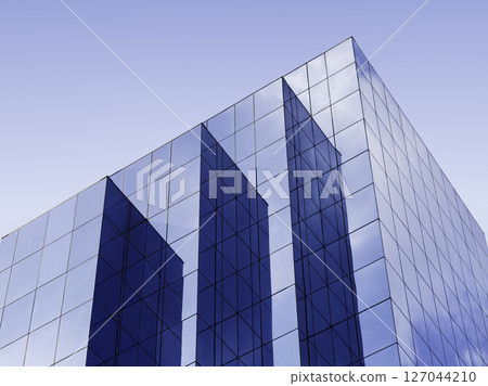 Modern building Glass facade Blue sky reflection Architecture details 127044210