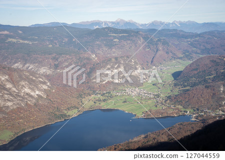 Aerial view on autumnal alpine landscape with mountains, lake and village, Slovenia, Europe 127044559