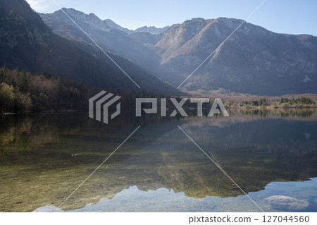 Calm alpine landscape with crystal clear lake reflecting surrounding mountains, Slovenia, Europe 127044560