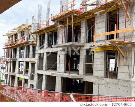 Modern concrete framework of new apartment building. Urban development in progress. Modern concrete framework of new apartment building. Urban development in progress. 127044603