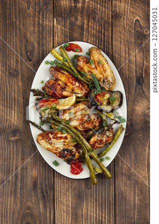 Freshly baked chicken wings. Freshly baked chicken wings. 127045031