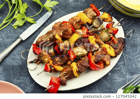Skewers with grilled meat and vegetables. Skewers with grilled meat and vegetables. 127045042
