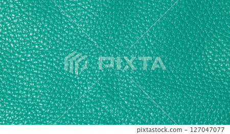 A close up full frame view of a vibrant teal colored leather texture, showcasing its natural grain A close up full frame view of a vibrant teal colored leather texture, showcasing its natural grain 127047077