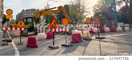Banner urban construction site with excavator and warning signs during street repairs. Urban infrastructure and public works 127047786