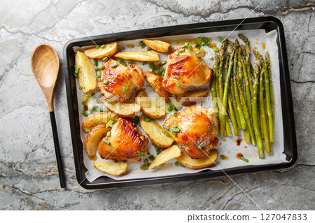 Sheet pan chicken with asparagus and potatoes close-up. horizontal top view Sheet pan chicken with asparagus and potatoes close-up. horizontal top view 127047833