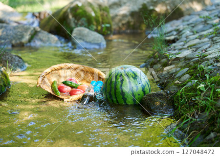Watermelon and summer vegetables cooled in stream water 127048472