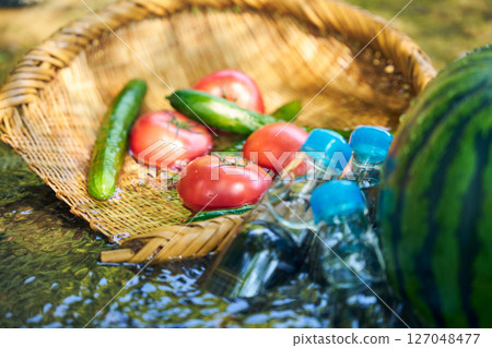 Watermelon and summer vegetables cooled in stream water 127048477
