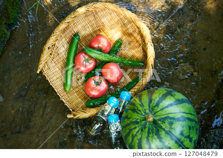 Watermelon and summer vegetables cooled in stream water Watermelon and summer vegetables cooled in stream water 127048479