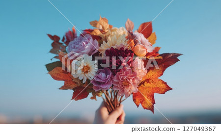 Autumnal Bouquet: Hand Holding Vibrant Pink Purple Orange Flowers and Leaves 127049367