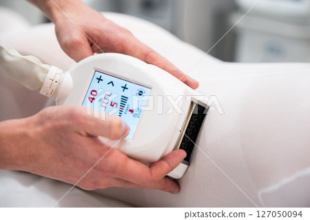 Advanced treatment device in use on patient during therapy session 127050094