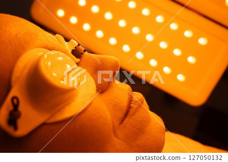 Relaxing skin treatment session under bright lights at spa 127050132