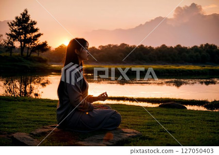 A woman relaxing in a park at dusk A woman relaxing in a park at dusk 127050403