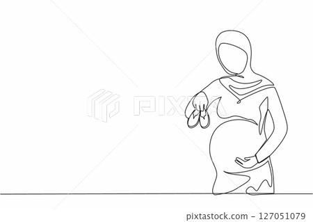 Single one line drawing small shoes for unborn baby in belly of pregnant woman. Arabian pregnant woman holding small baby shoes relaxing at home in bedroom. Continuous line draw design graphic vector 127051079
