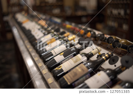 Row of wine bottles with dry red and white wine on wooden. Low depth of field. 127051385