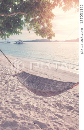 Hammock on the beach of a tropical island, color toning applied, Philippines. 127051562