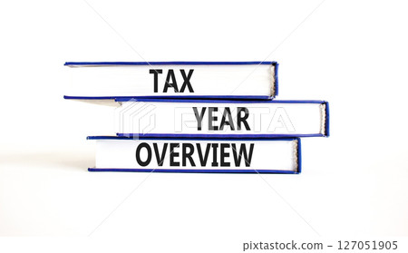 Tax year overview symbol. Concept words Tax year overview on beautiful blue white books. Beautiful white background. Business tax year overview concept. Copy space. Tax year overview symbol. Concept words Tax year overview on beautiful blue white books. Beautiful white background. Business tax year overview concept. Copy space. 127051905