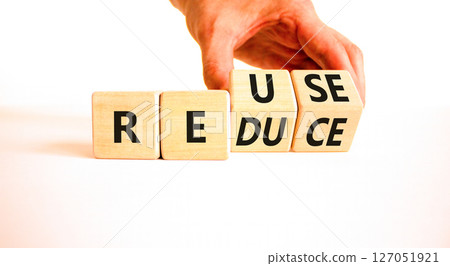 Reuse or reduce symbol. Concept words Reuse Reduce on wooden block. Beautiful white table white background. Businessman hand. Business reuse or reduce concept. Copy space. Reuse or reduce symbol. Concept words Reuse Reduce on wooden block. Beautiful white table white background. Businessman hand. Business reuse or reduce concept. Copy space. 127051921