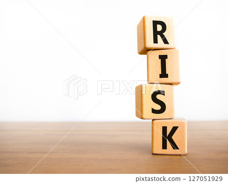 Risk symbol. Concept word Risk on beautiful wooden blocks. Beautiful wooden table white background. Business, lifestyle, support and risk concept. Copy space. Risk symbol. Concept word Risk on beautiful wooden blocks. Beautiful wooden table white background. Business, lifestyle, support and risk concept. Copy space. 127051929