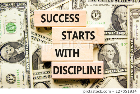 Success starts with discipline symbol. Concept words Success starts with discipline on beautiful wooden blocks. Beautiful dollar background. Business success starts with discipline concept. Copy space 127051934