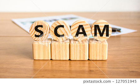 Scam symbol. Concept word Scam on beautiful wooden circles on wooden blocks. Beautiful wooden table white background. Business, lifestyle, support and scam concept. Copy space. 127051945