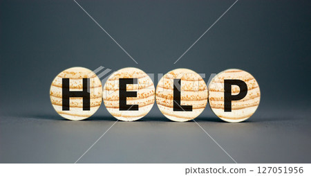 Help symbol. Concept word Help on beautiful wooden circles. Beautiful grey table grey background. Business, lifestyle, support and help concept. Copy space. 127051956