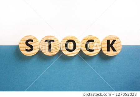 Stock symbol. Concept word Stock on beautiful wooden circles. Beautiful white and blue background. Business lifestyle stock concept. Copy space. 127052028