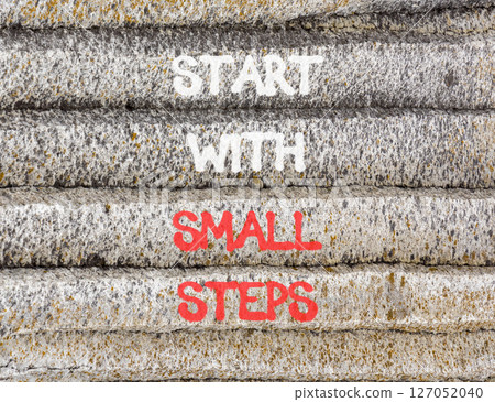 Start with small steps symbol. Concept words phrase Start with small steps on beautiful grey stone wall. Beautiful stone wall background. Business Start with small steps concept. Copy space. 127052040