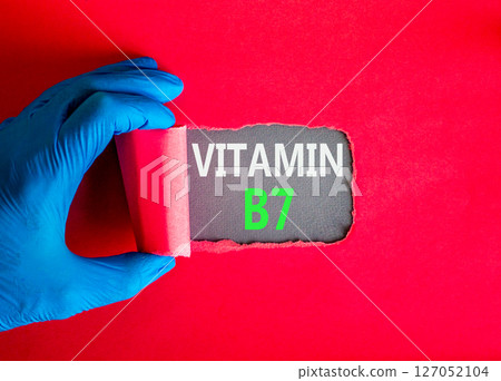 Vitamin B7 biotin symbol. Concept words Vitamin B7 on beautiful grey paper. Doctor hand in blue medical glove. Beautiful red background. Medical healthy lifestyle Vitamin B7 concept. Vitamin B7 biotin symbol. Concept words Vitamin B7 on beautiful grey paper. Doctor hand in blue medical glove. Beautiful red background. Medical healthy lifestyle Vitamin B7 concept. 127052104