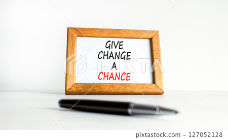 Give change a chance symbol. Concept words phrase Give change a chance on beautiful wooden picture frame. Black pen. Beautiful white background. Business Give change a chance concept. Copy space. Give change a chance symbol. Concept words phrase Give change a chance on beautiful wooden picture frame. Black pen. Beautiful white background. Business Give change a chance concept. Copy space. 127052128