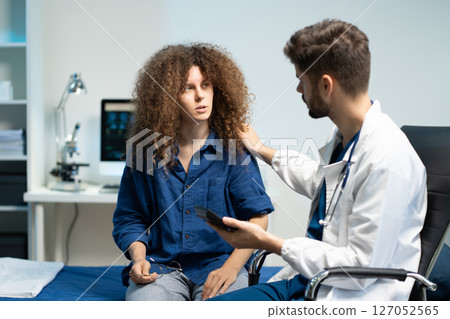 Stressed woman patient are treated by a psychologist or psychiatrist in a psychiatric clinic or hospital. Stressed woman patient are treated by a psychologist or psychiatrist in a psychiatric clinic or hospital. 127052565