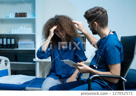 Stressed woman patient are treated by a psychologist or psychiatrist in a psychiatric clinic or hospital. Patients reported symptoms of depression, stress, irritability, and life problems. Stressed woman patient are treated by a psychologist or psychiatrist in a psychiatric clinic or hospital. Patients reported symptoms of depression, stress, irritability, and life problems. 127052571