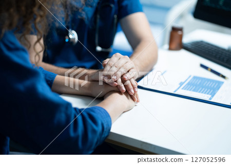 doctor talking with woman patient for monitoring and check up after surgery. doctor touching patient hand and consoling. doctor talking with woman patient for monitoring and check up after surgery. doctor touching patient hand and consoling. 127052596
