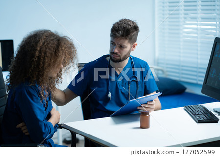 doctor talking with woman patient for monitoring and check up after surgery. doctor touching patient hand and consoling. doctor talking with woman patient for monitoring and check up after surgery. doctor touching patient hand and consoling. 127052599