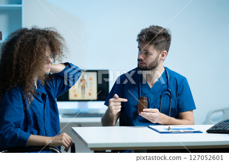 Professional male therapist gives medication advice to a woman patient in a caring clinical setting. therapy, wellness, and consultation visuals. Professional male therapist gives medication advice to a woman patient in a caring clinical setting. therapy, wellness, and consultation visuals. 127052601