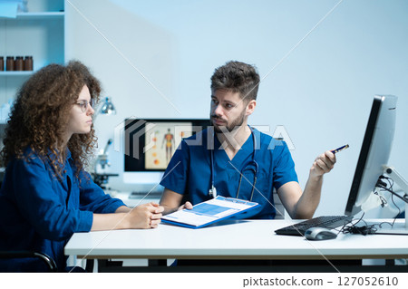 male doctor explaining to patient results of model brain. Diagnosis of diseases and head injuries. male doctor explaining to patient results of model brain. Diagnosis of diseases and head injuries. 127052610