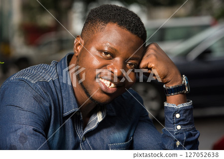 close up of young african man smiling. 127052638