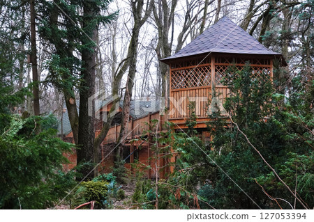 Kyiv, Ukraine January 27, 2025:  Wooden log house made of wood on the territory of the Botanical Garden of the National University of Life and Environmental Sciences of Ukraine 127053394