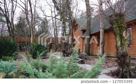 Kyiv, Ukraine January 27, 2025:  Wooden log house made of wood on the territory of the Botanical Garden of the National University of Life and Environmental Sciences of Ukraine 127053395