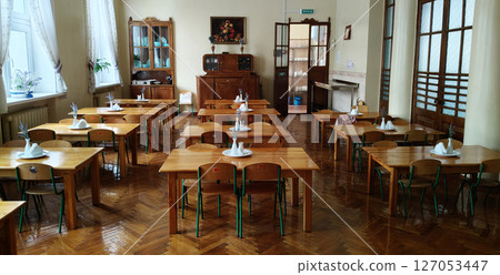 Kyiv, Ukraine March 4, 2025: Interior of a dining room in a kindergarten from the 1960-1970s with furniture, a chest of drawers and a painting in a classical style. 127053447