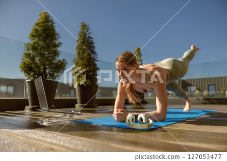 Join an energizing Outdoor Yoga session with a Fitness Wheel to boost your fitness journey 127053477