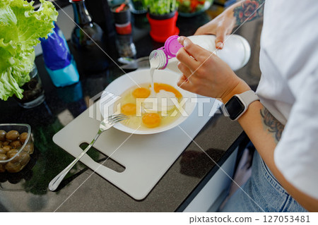 The Cooking Process Involving Eggs and Various Fresh Ingredients in a Modern Kitchen Setup The Cooking Process Involving Eggs and Various Fresh Ingredients in a Modern Kitchen Setup 127053481