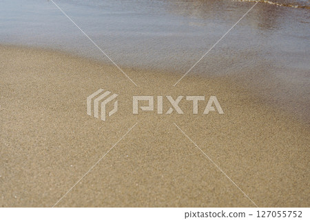 Wet sand on the beach 127055752