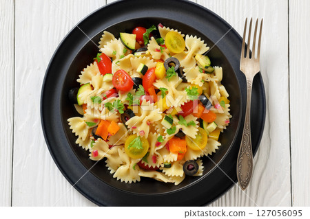 salad of farfalle pasta with veggies and olives salad of farfalle pasta with veggies and olives 127056095