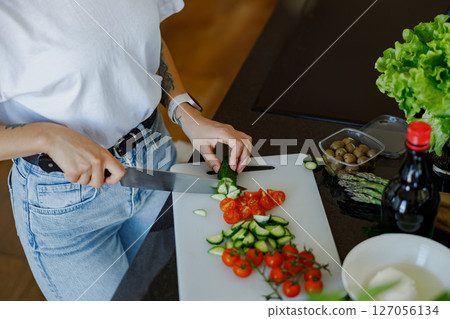 Healthy Cooking Skillfully Slicing Fresh, Colorful Vegetables in the Modern Kitchen Healthy Cooking Skillfully Slicing Fresh, Colorful Vegetables in the Modern Kitchen 127056134