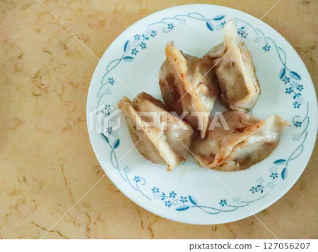 close up of pan fried Chinese stuffed minced pork and vegetables dumplings with copy space close up of pan fried Chinese stuffed minced pork and vegetables dumplings with copy space 127056207