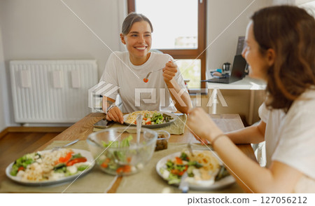 Indulging in a Wholesome and Healthy Meal with Close Friends in the Comfort of Home 127056212