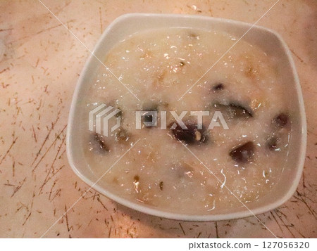close up of Hong Kong Chinese congee with pork and century egg with copy space 127056320