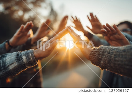 Radiant Circle of Hands Forming a Protective Barrier at Sunset in a Natural Setting Radiant Circle of Hands Forming a Protective Barrier at Sunset in a Natural Setting 127056567